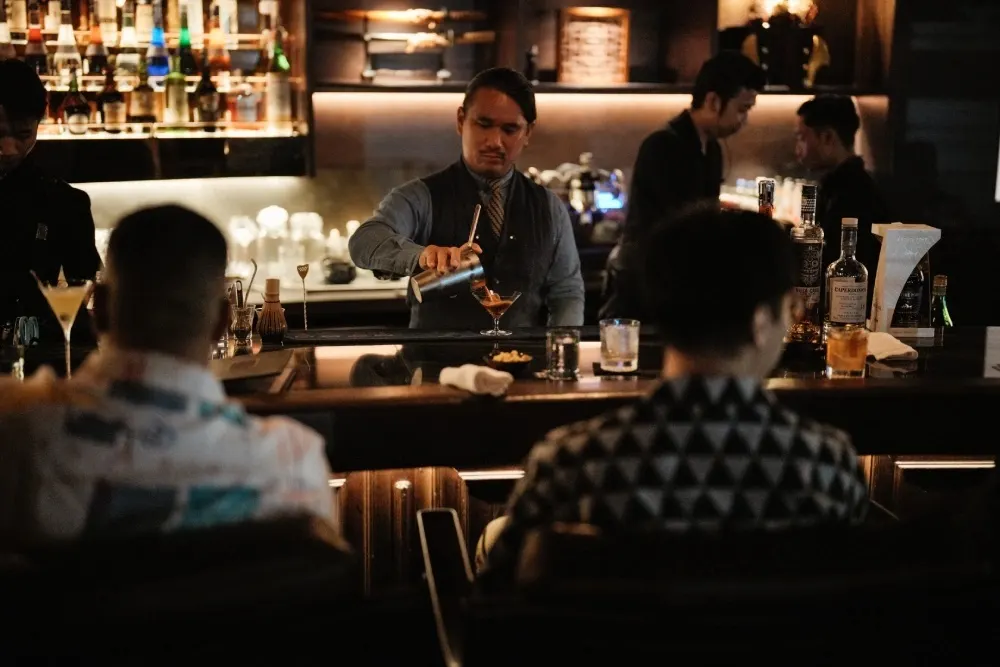 A drink presented to guests across the bar at AOKU.
