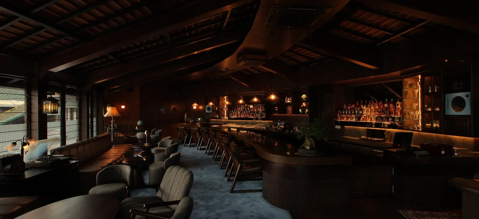 The curved bar, booths and timber ceiling at AOKU, upstairs from Dahana in Seminyak.