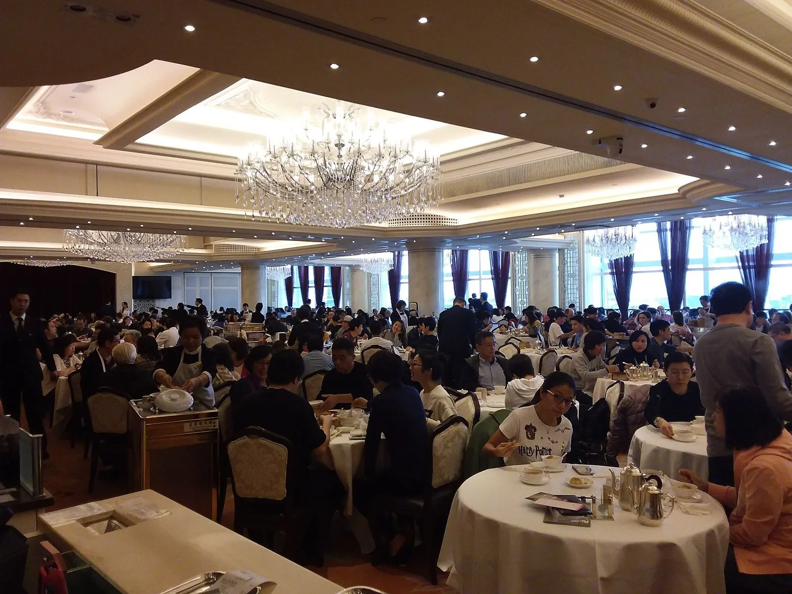 The chandeliered dining hall of Maxim's Palace at City Hall