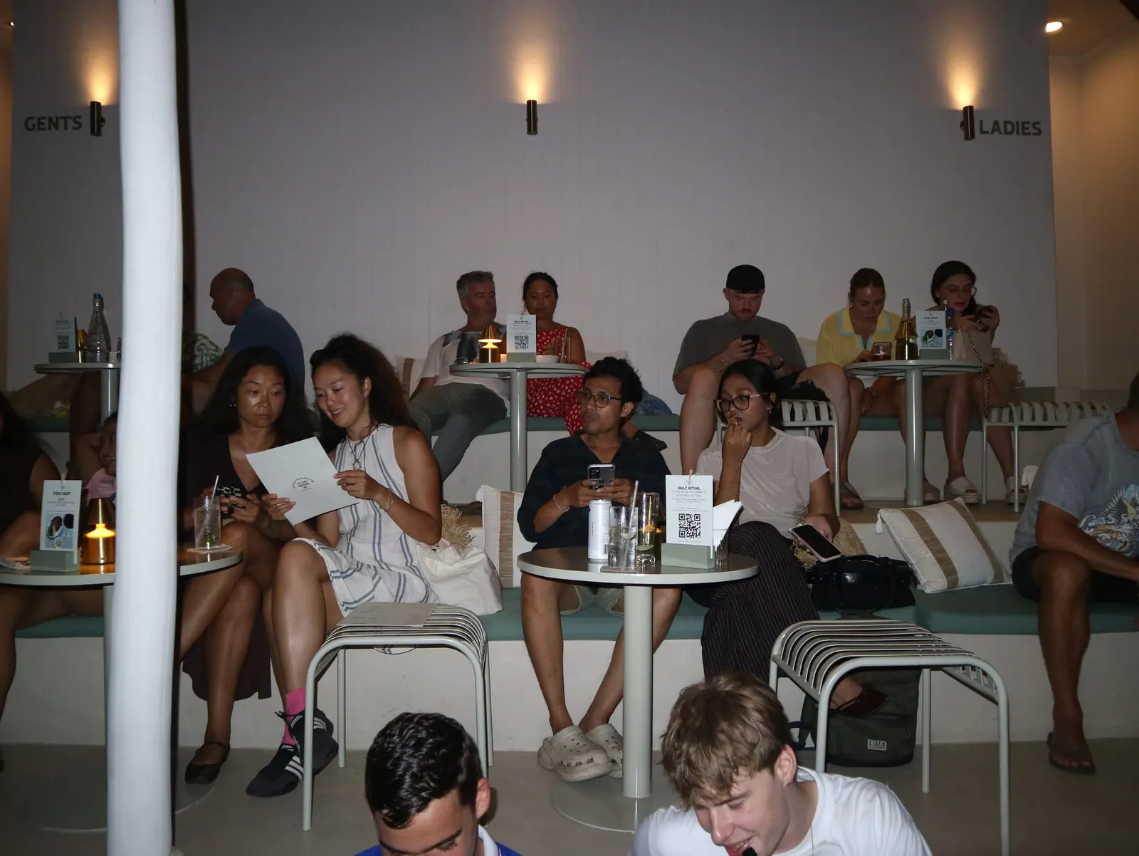 Guests competing in teams during Trivia Thursday at Club House Pererenan, with a full room of players at their tables