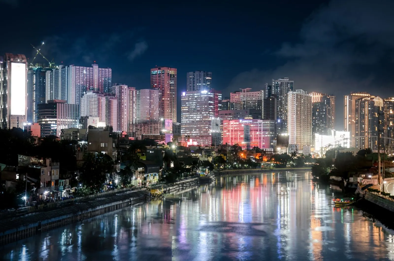 Makati skyline at night reflected in the river