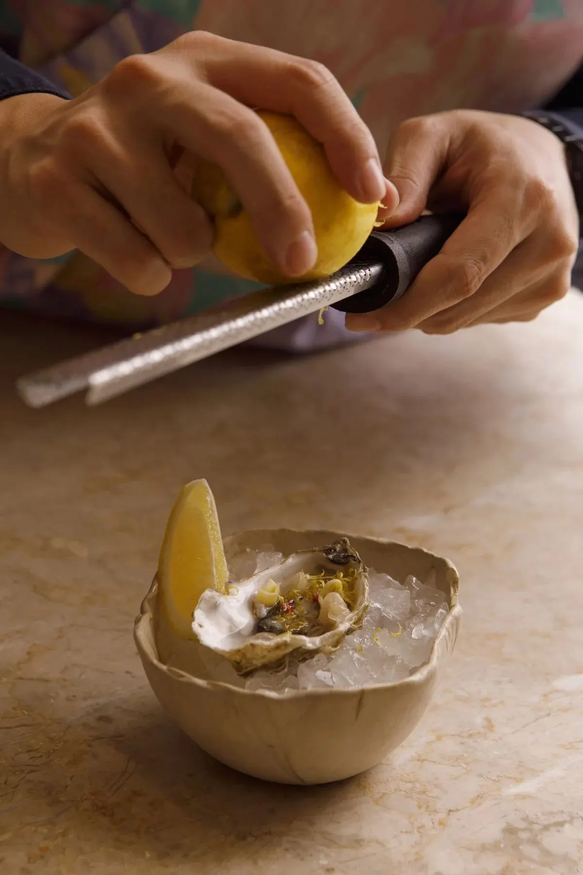 An oyster being finished with zest at Inatô