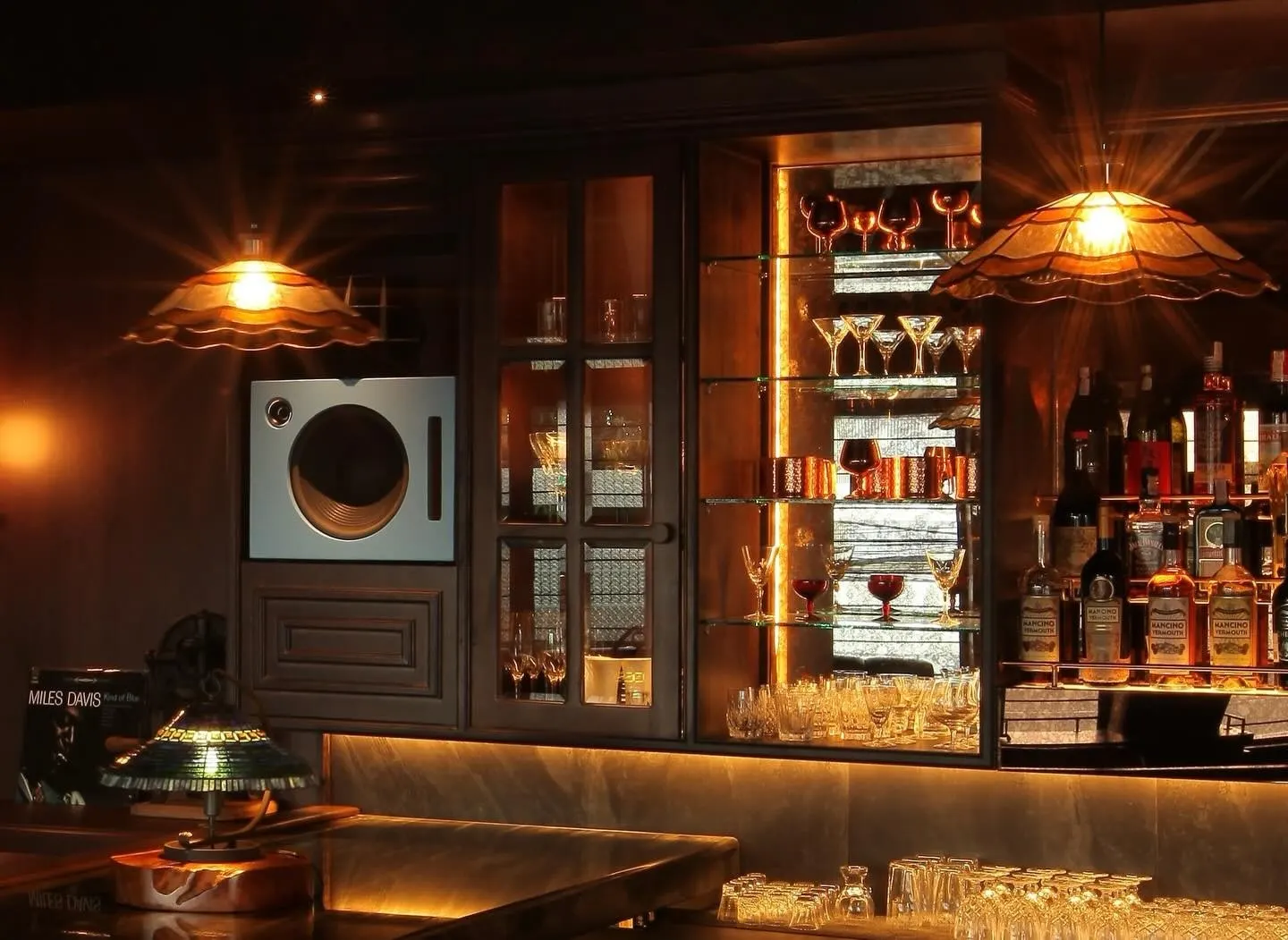The AOKU back bar with a turntable, vinyl and fringed lamps.