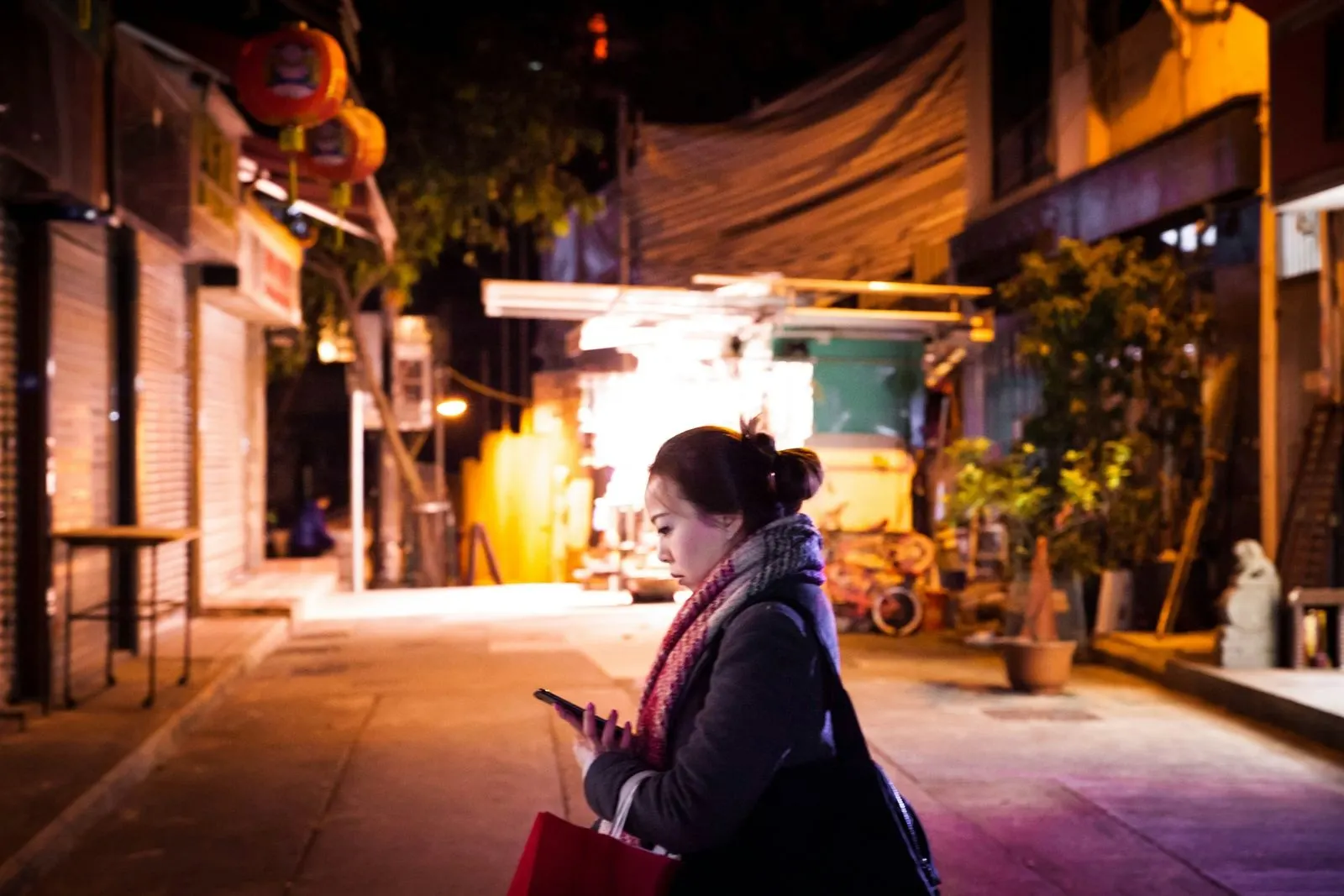 A Hong Kong lane at night with red lanterns