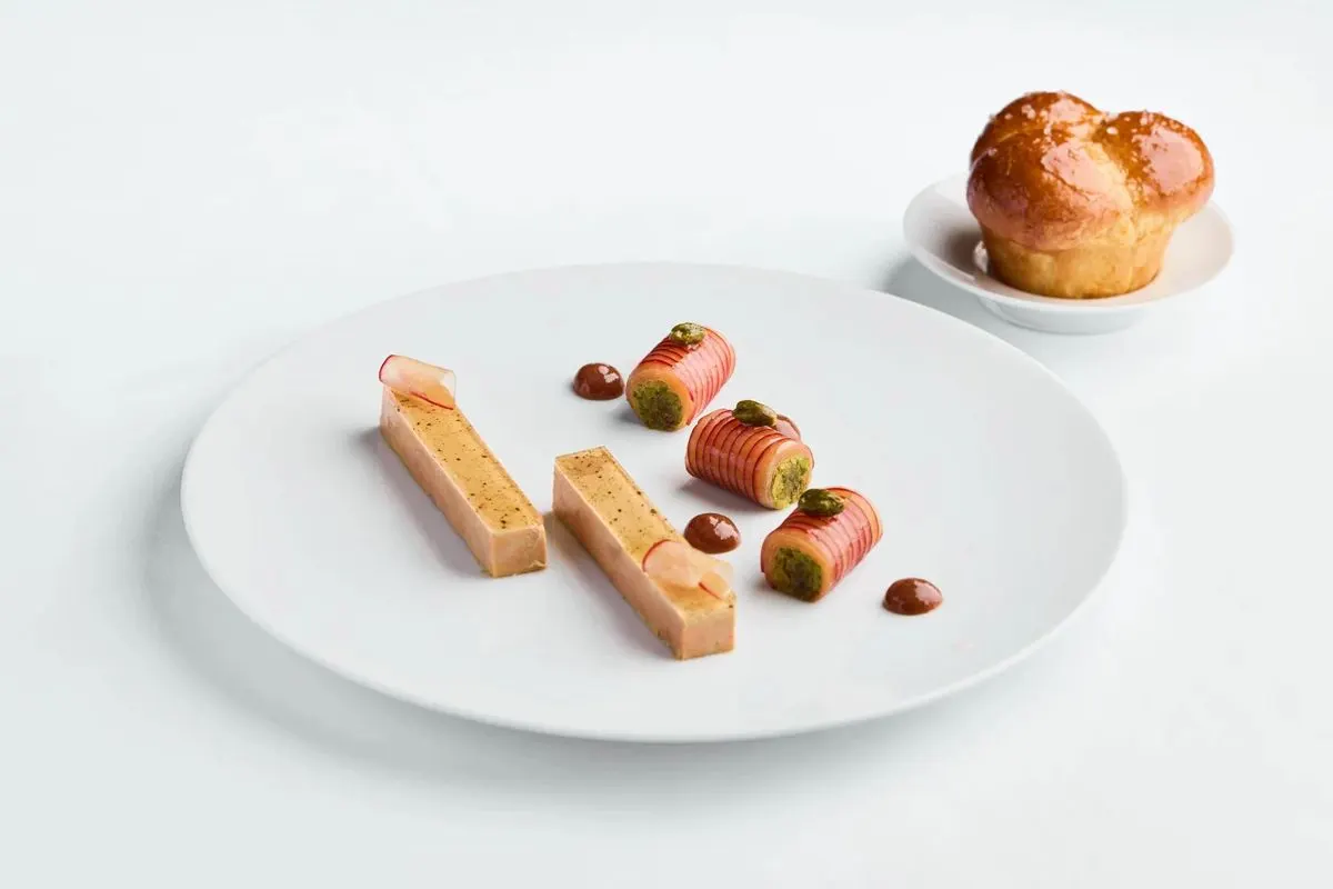 A plated dish with brioche at Belon