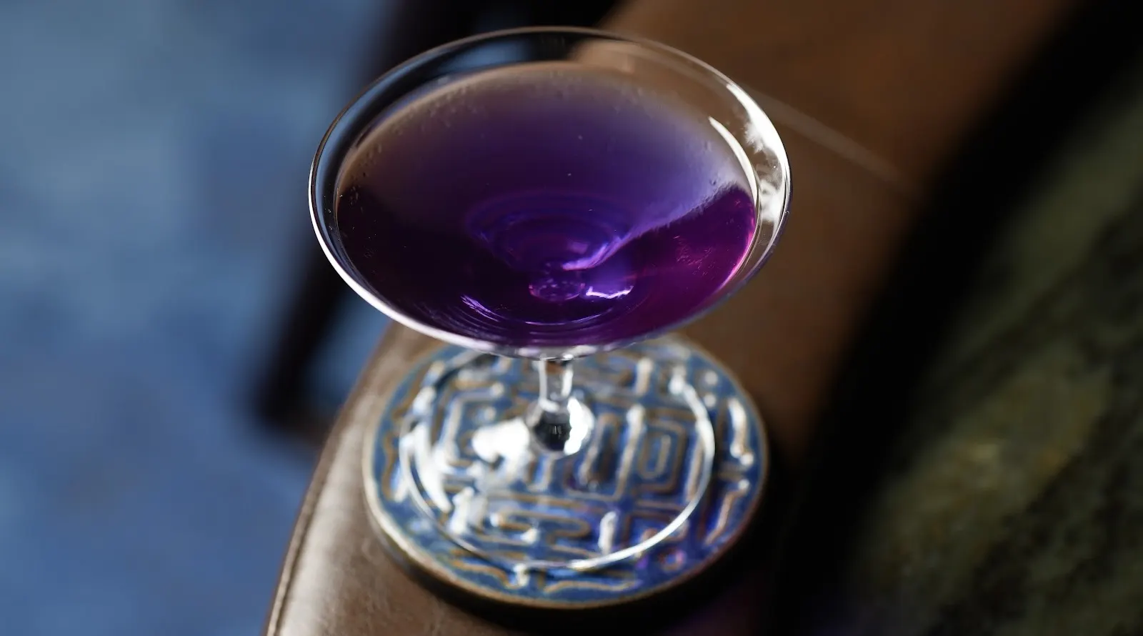 Murasaki, a violet butterfly pea cocktail in a coupe on an AOKU coaster.