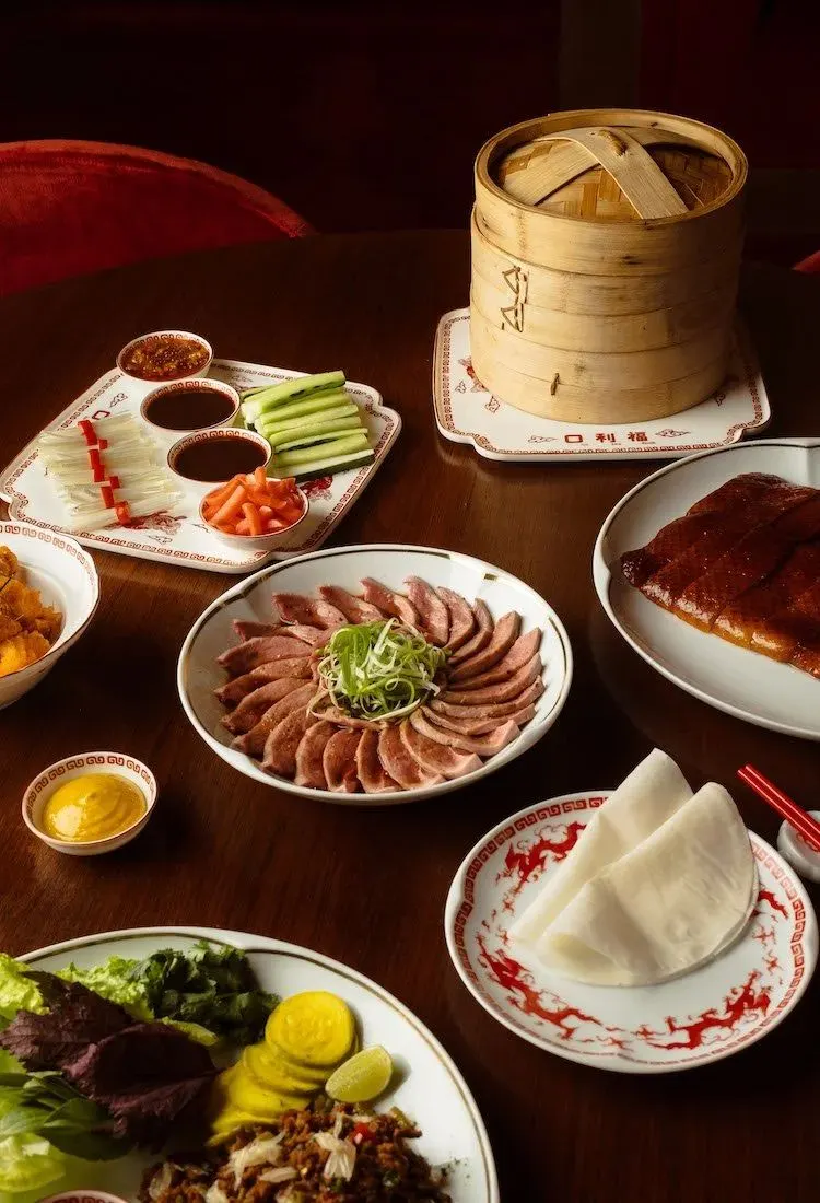A table spread of dishes at Ho Lee Fook